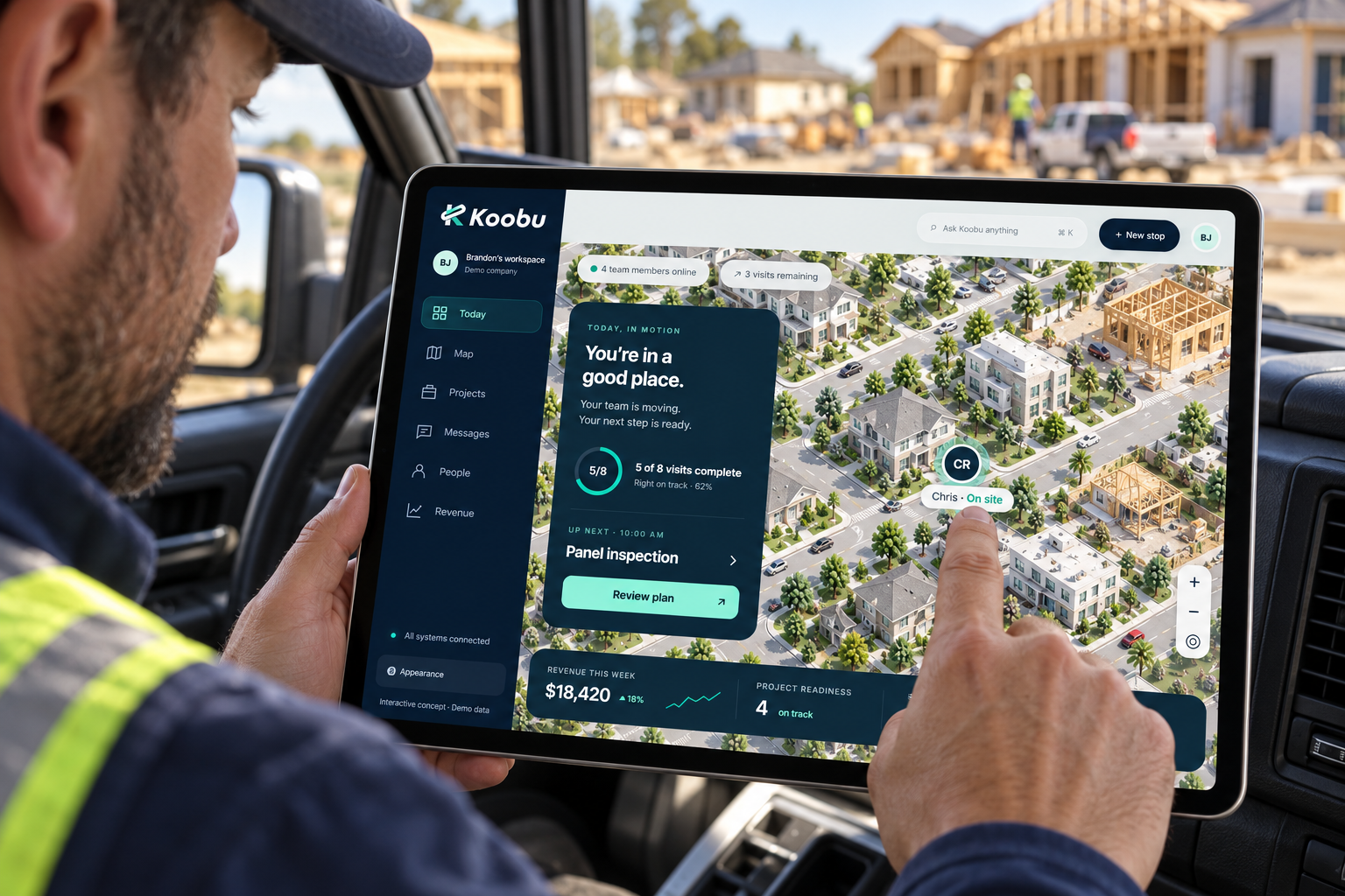 Construction manager reviewing Koobu on an iPad in a parked truck