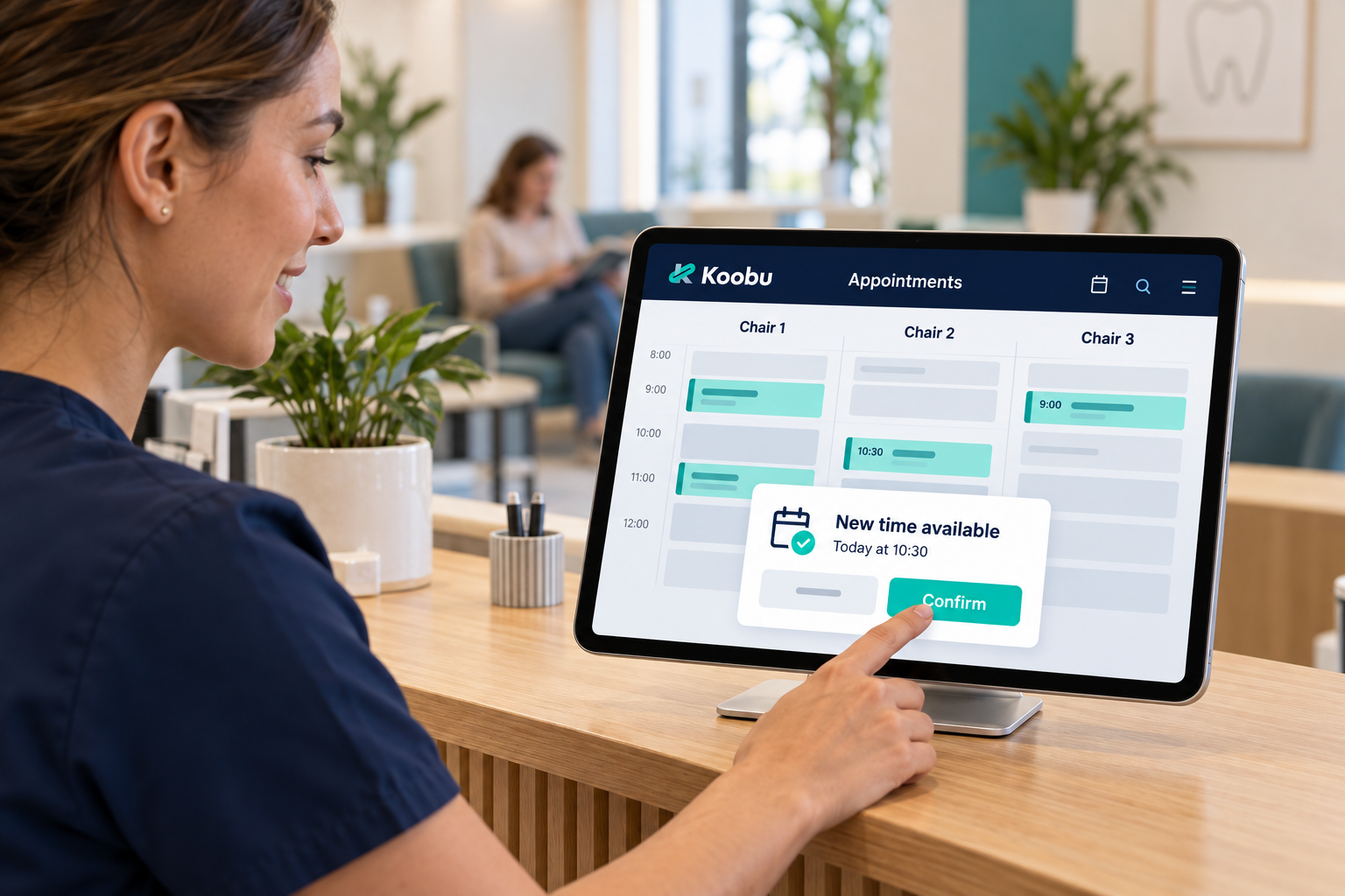 Receptionist reviewing a Koobu appointment calendar on an iPad